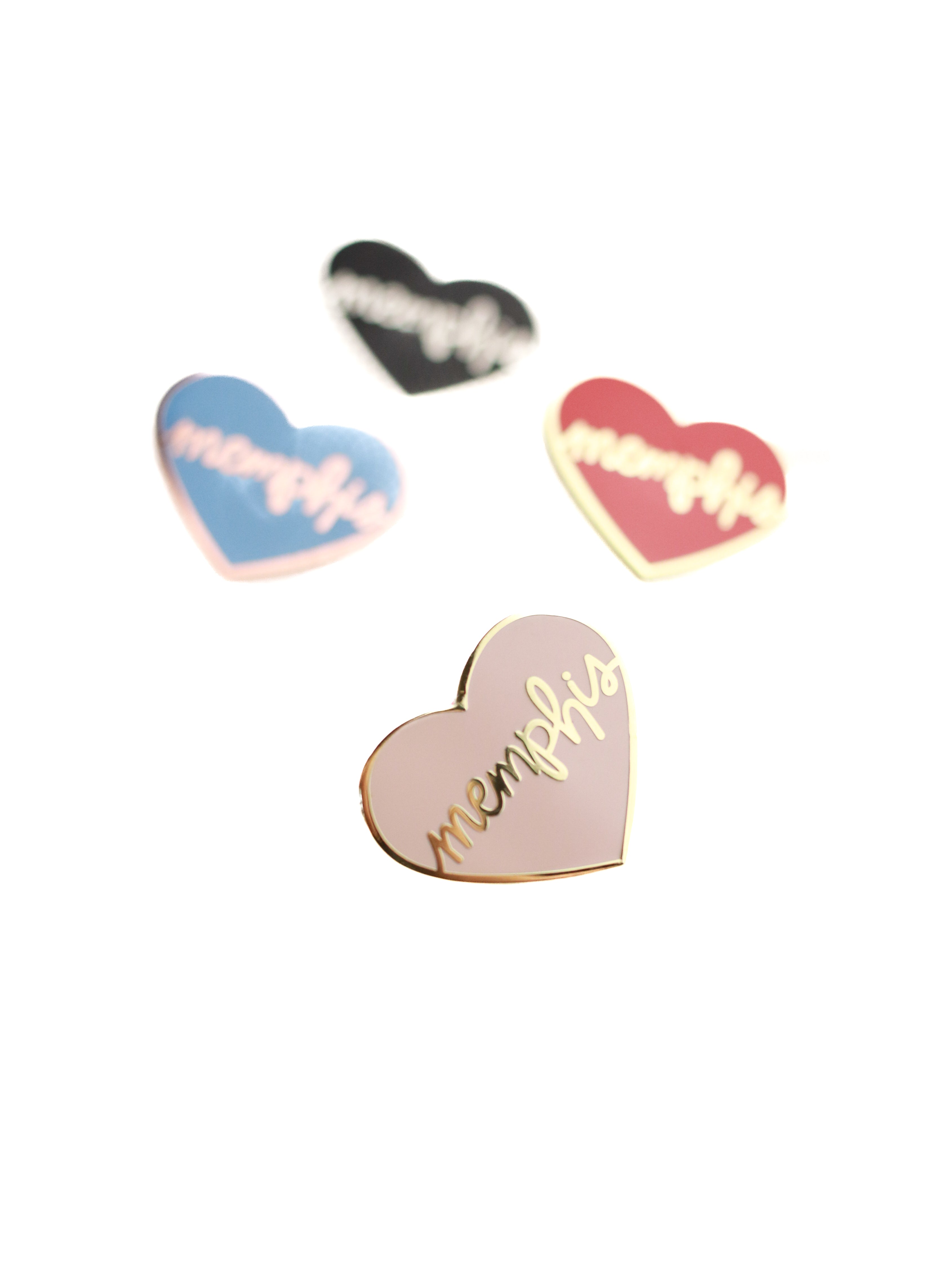 4 heart memphis enamel pins on white background pink with gold lettering in focus