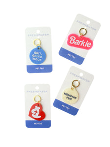 multiple acrylic pet tags on paper backing and white background