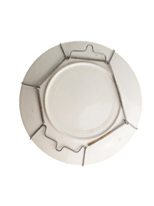 Ceramic plate with Metallic circular holder on white background