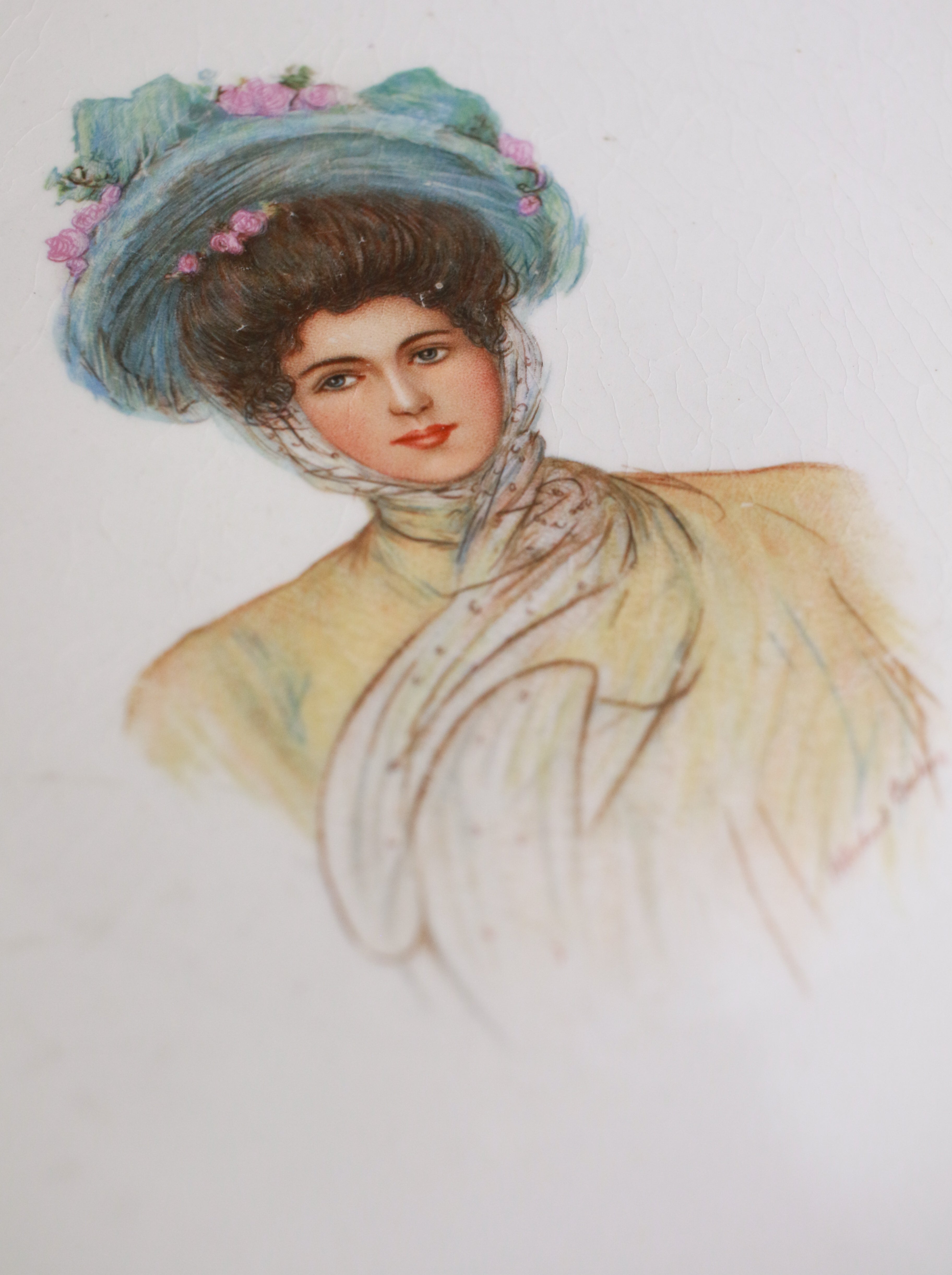 Vintage-style portrait of a woman with a blue hat and floral decorations on a light background