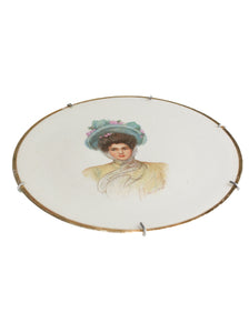 Decorative plate with a portrait of a woman in a pastel setting laying down