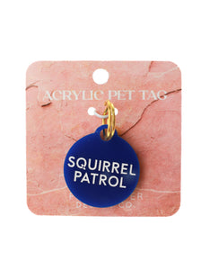 blue circle squirrel partrol dog tag with white lettering on pink paper and white background