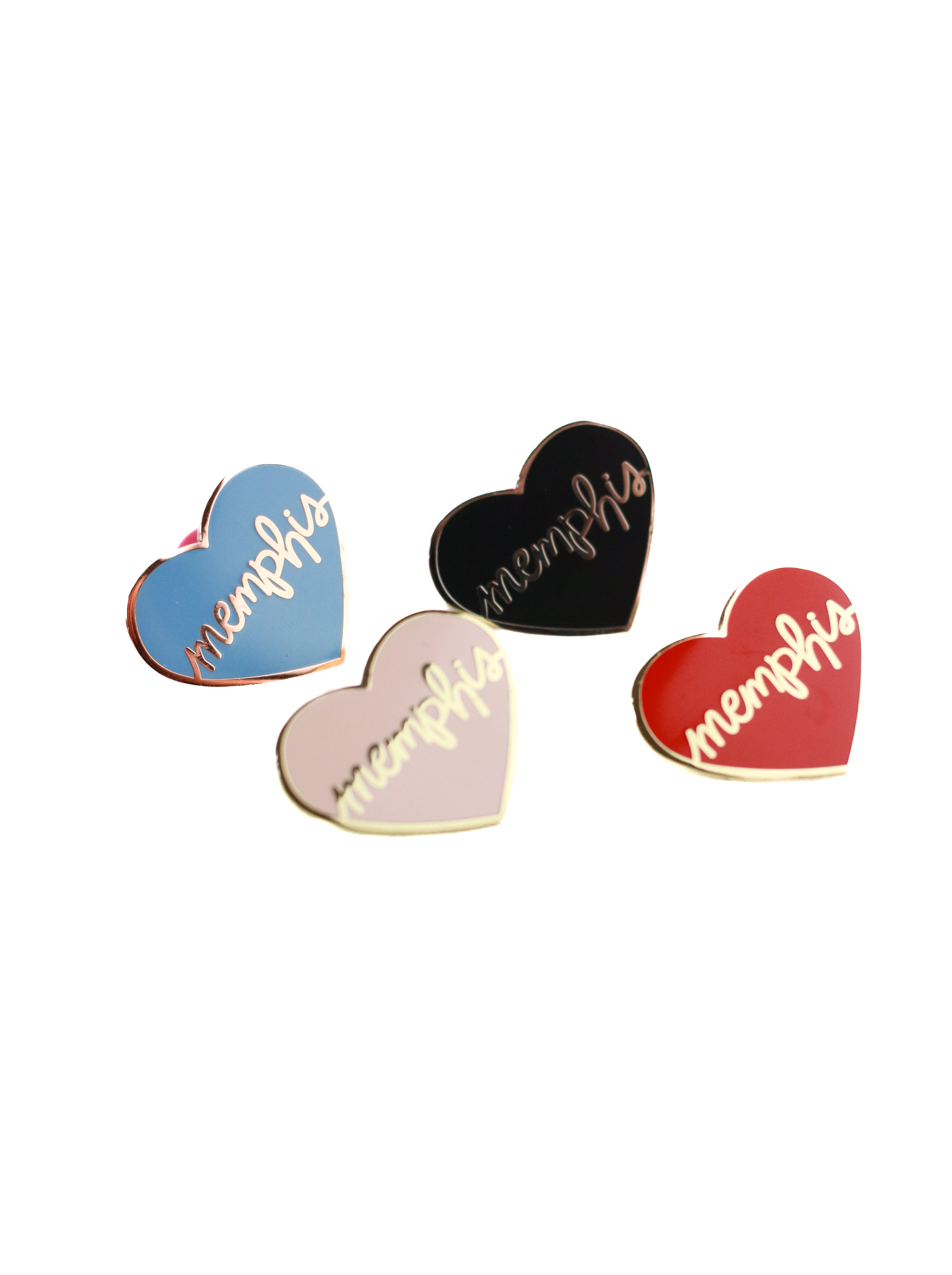 4 heart enamel pins on white backdrop 