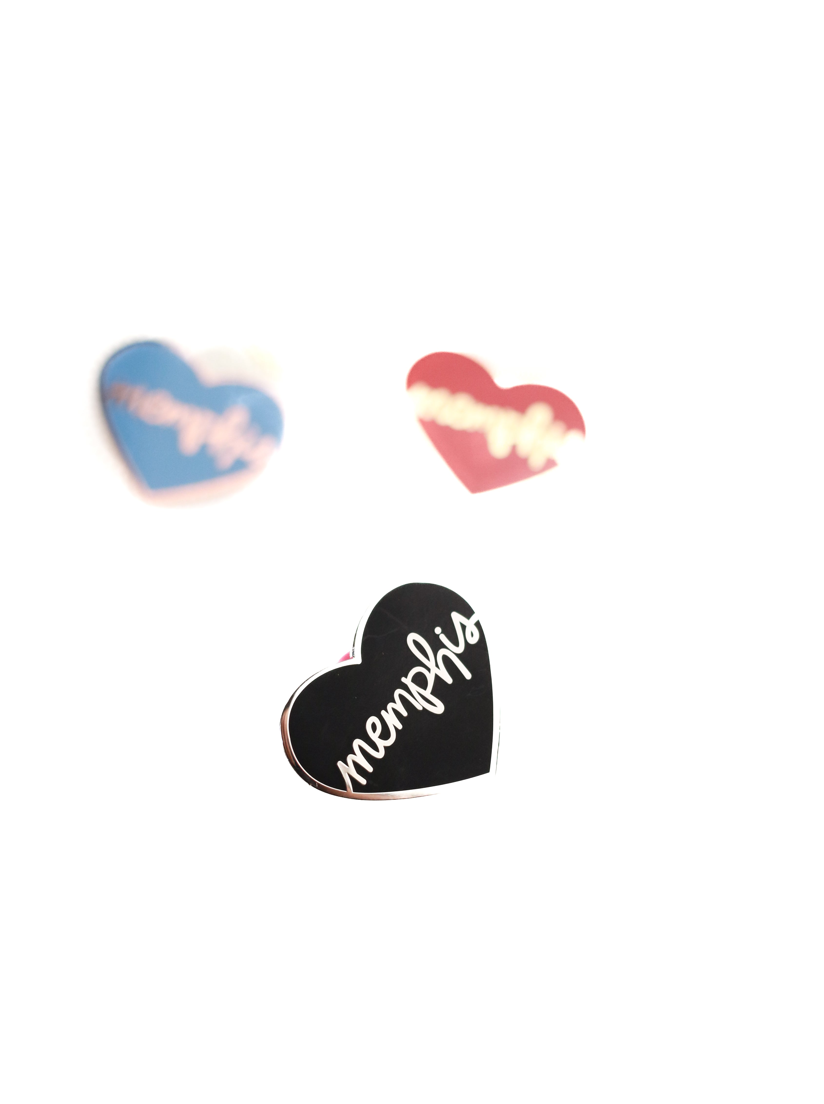 3 heart memphis enamel pins on white background black heart in focus